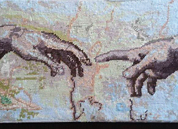haftowany obraz stykających się dłoni