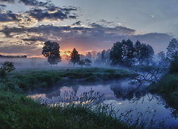 wschód słońca nad pokrytymi mgłą łąkami i rzeką