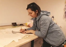 Kobieta odrysowuje szablon na papierze