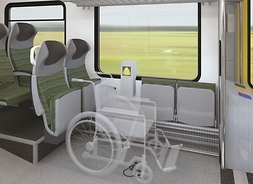 wnętrze pociągu, widać fotele, miejsca dla niepełnosprawnych i okna