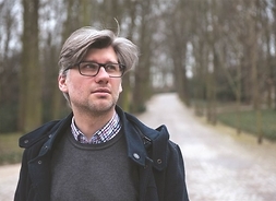 Poeta i publicysta Adrian Sinkowski w okularach, zdjęcie w plenerze