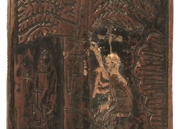 Drewniana deska z płaskorzeźbionymi znakami