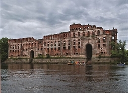 widok na budynek murowany nad rzeką, widok z perspektywy rzeki