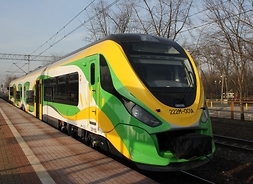 nowoczeny pociąg typu Flirt należący do Kolei Mazowieckich w barwach żółto-zielono-białych stoi na stacji