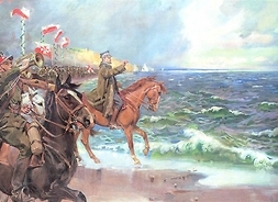 Obraz, na którym widać na pierwszym planie żołnierzy na koniach na brzegu morza z polskimi flagami. W tle żołnierze piechoty